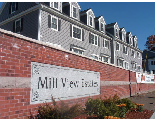 Front view of a multi-story residential building named Mill View Estates.