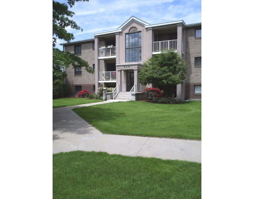Front view of a multi-story residential building with balconies.