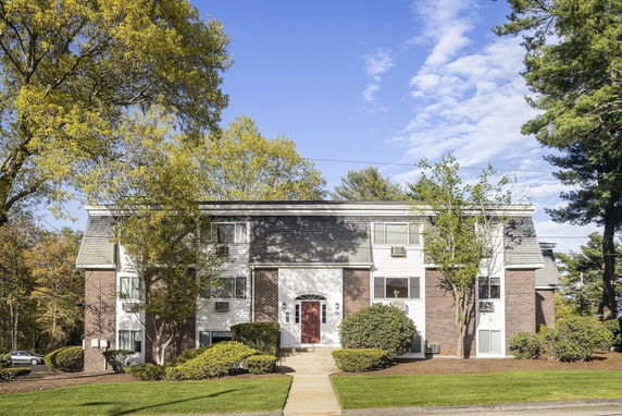 Front view of a two-story brick residential building with a central entrance.