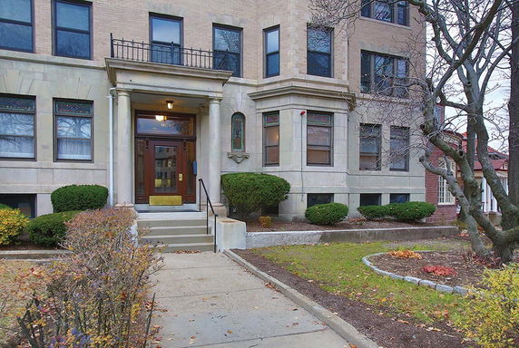 Front view of a building with a central entrance and multiple windows.
