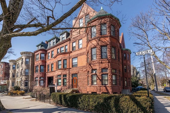 Front view of a historic multi-story brick building on Beacon Street.