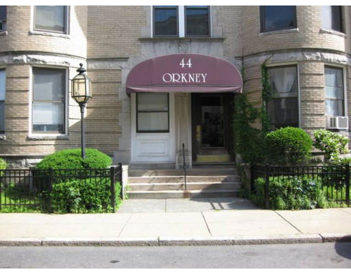 Front view of a multi-story building with a maroon awning labeled '44 ORKNEY'.