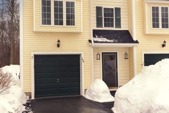Front view of a two-story house with a garage.