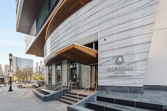 Front view of a modern building with a curved façade and sleek design.