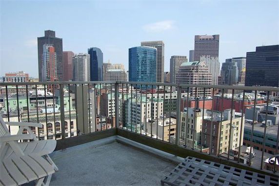 Panoramic view of a city skyline from a rooftop.