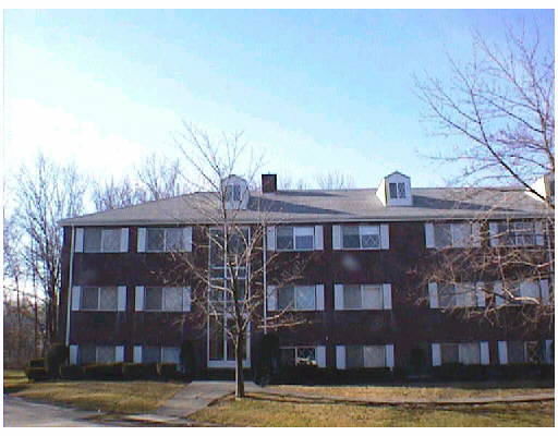 Front view of a three-story brick apartment building.