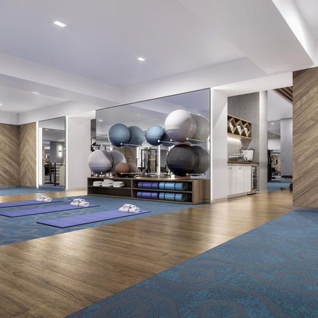 Interior of a gym area with yoga mats and exercise balls.