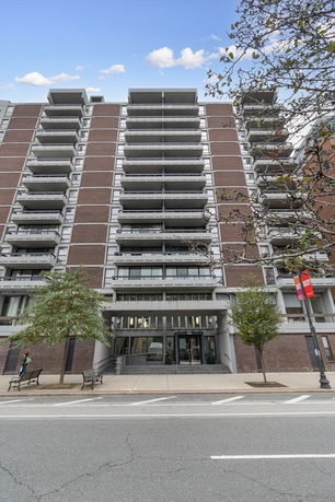 Front view of a multi-story residential building with balconies.
