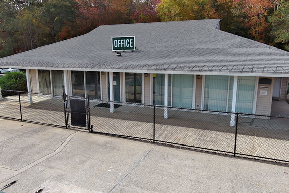 Front view of a single-story office building with a gable roof and large windows.