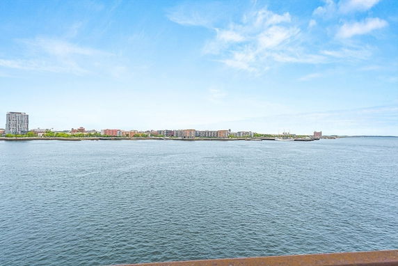 Wide-angle view of buildings across a body of water.