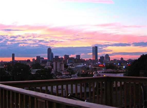 Wide-angle view of a city skyline during sunset.