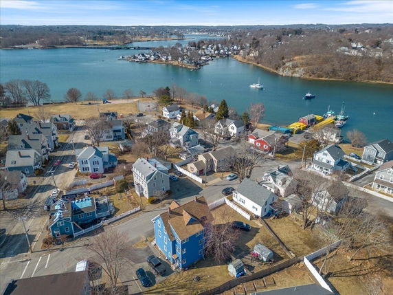 Aerial view of a residential area with houses and waterway.