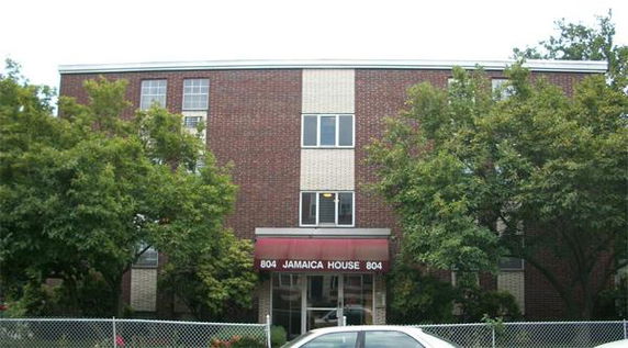 Front view of a three-story brick apartment building