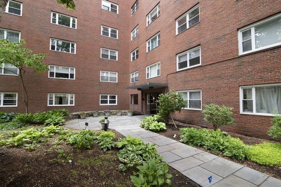 Front view of a multi-story brick apartment building.