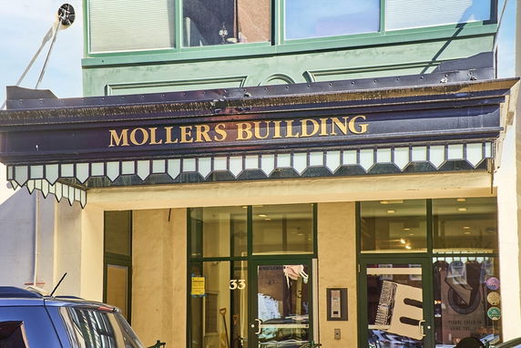 Front view of a building with the name 'Mollers Building' on the entrance awning.