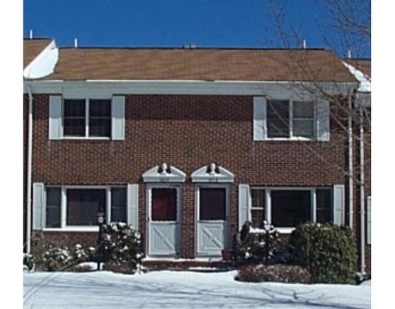 Front view of a two-story brick townhouse with two entrances.
