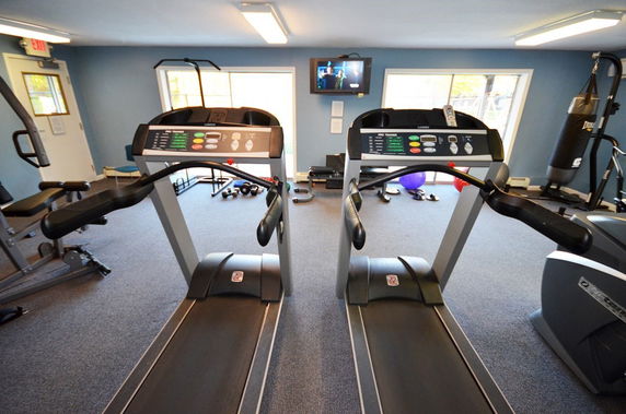 Indoor gym area with treadmills and exercise equipment.