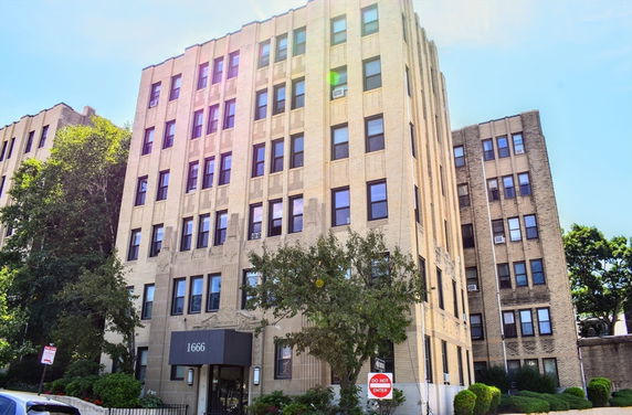 Front view of a multi-story building with a prominent entrance.