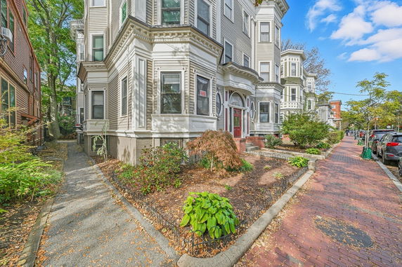 Front view of a multi-story residential building with ornate architectural details.