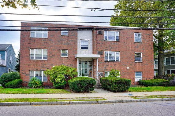 Front view of a multi-story brick apartment building