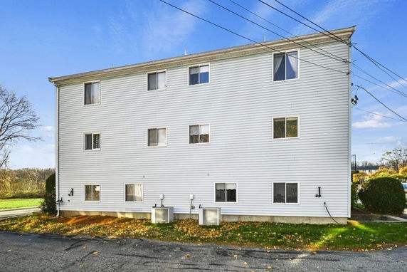 Side view of a multi-story building with multiple windows.
