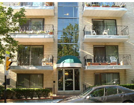 Front view of a multi-story apartment building with balconies.