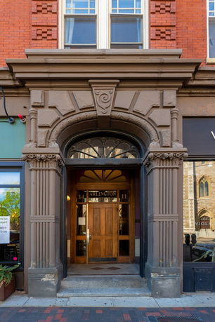 Front view of an ornate building entrance with detailed architecture.