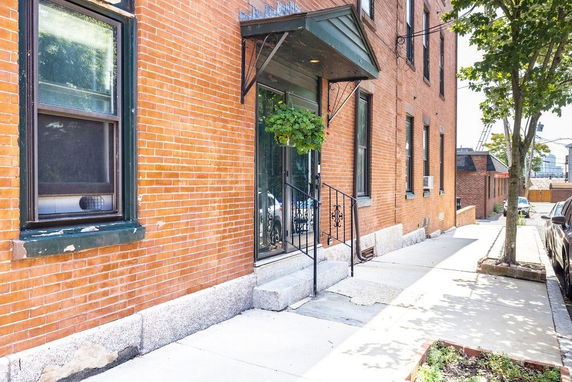 Front view of a brick building with a small entrance canopy.