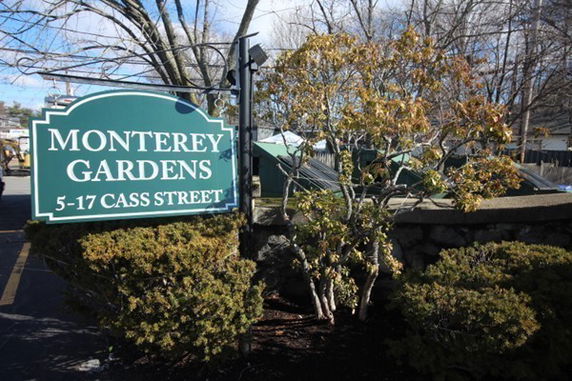 Front view of a building with a Monterey Gardens sign.