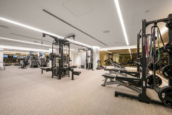 Indoor gym area with exercise machines and equipment.