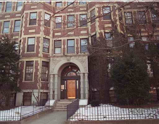 Front view of a multi-story brick apartment building.