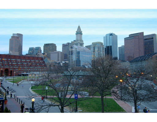 Skyline featuring tall buildings and a clock tower in an urban setting.