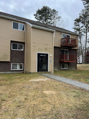 Front view of a two-story apartment building with an entrance marked 'Units 13-18'.