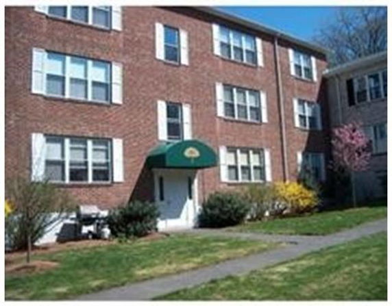 Front view of a multi-story brick apartment building.
