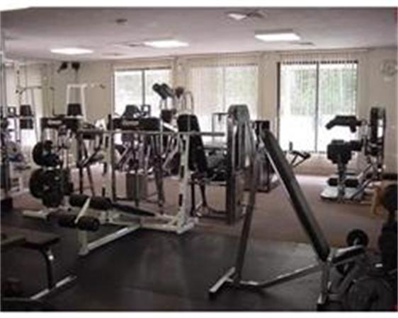 Indoor fitness area with various exercise machines and equipment.