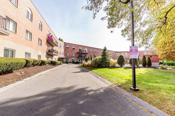 Front view of a three-story apartment building with balconies.