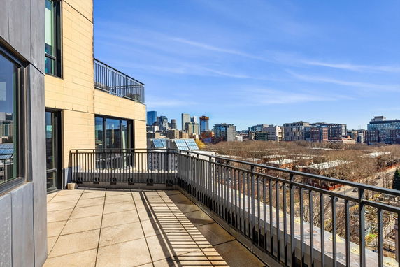 Rooftop terrace offering a panoramic view of the city skyline.