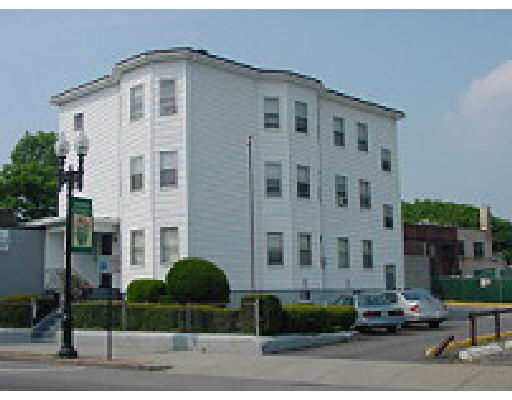 Front view of a multi-story building with multiple windows.
