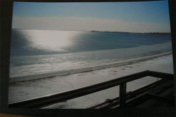 View from a building overlooking a beach and the ocean.