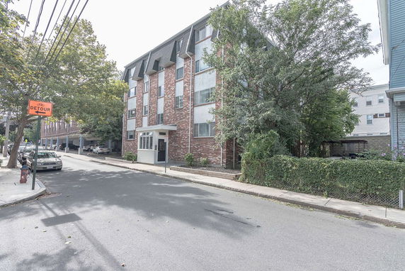 Front view of a multi-story brick apartment building.