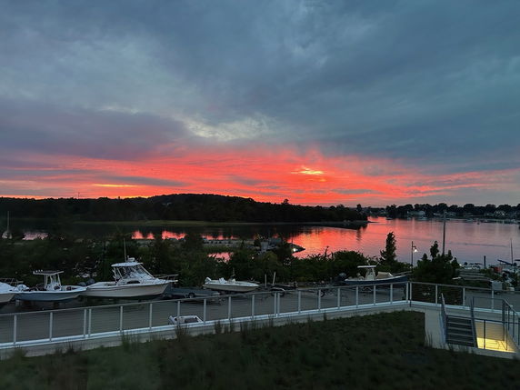 Panoramic view of a waterfront area with a vivid sunset.