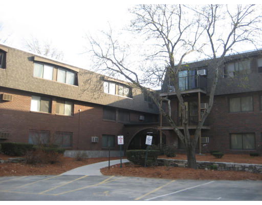 Front view of a multi-story brick building with large windows and a central entrance.