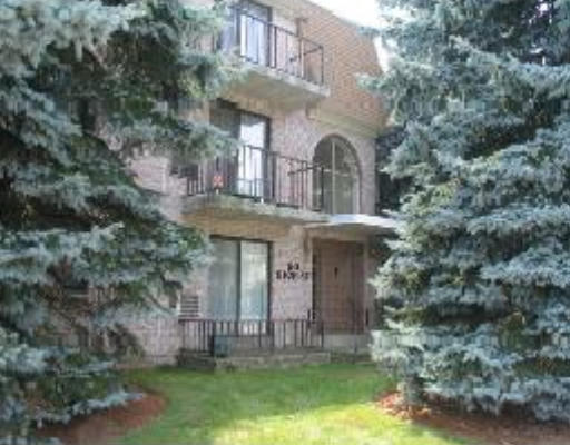 Front view of a multi-story building with balconies and large windows.