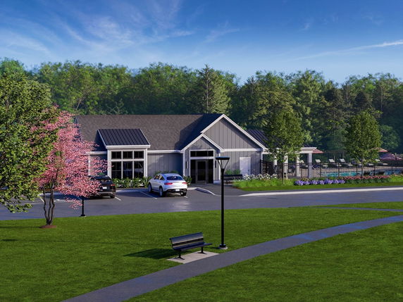 Front view of a single-story house with a driveway and garden.