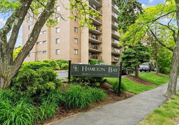 Front view of a multi-story apartment building with balconies.