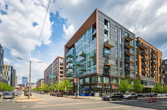 Front view of a modern multi-story building with glass and metal facade.