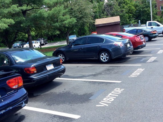 Visitor parking area with multiple cars parked in designated spots.