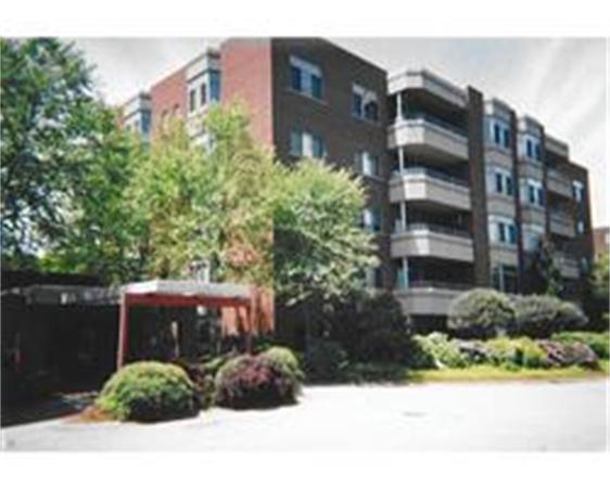 Front view of a multi-story building with balconies.