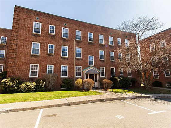 Front view of a three-story brick apartment building