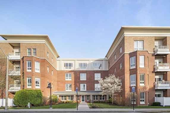 Front view of a multi-story brick apartment building.